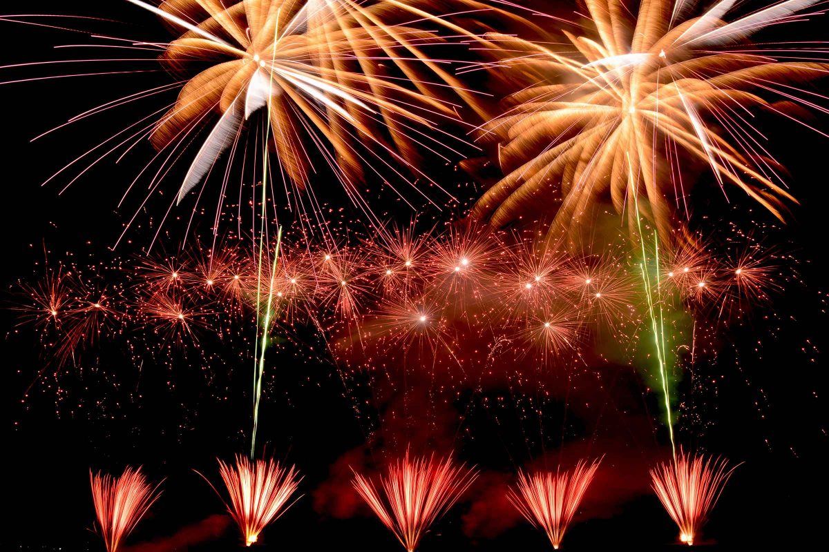 Firework display over the countryside at night