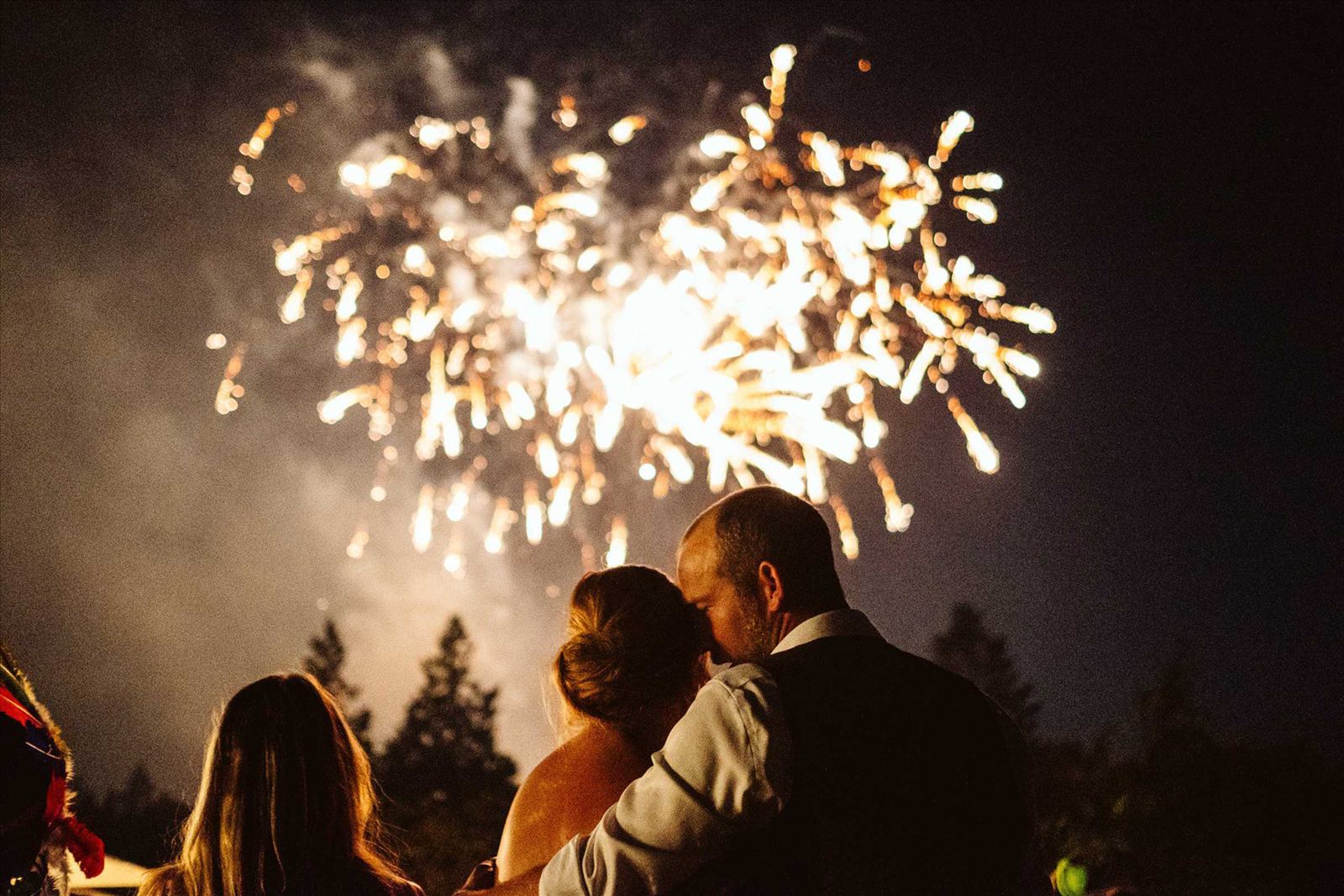 Wedding firework display lighting up the night sky above a country-house venue
